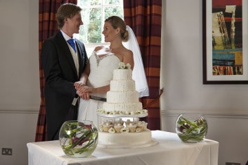 Bride and groom cutting the cake in Princess Suite