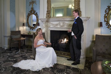 Bride and groom by the fireplace in the Drawing Room