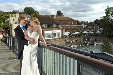 Bride and groom photographed on Eton Bridge
